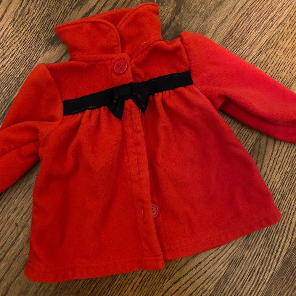 Red fleece jacket with black bow detail